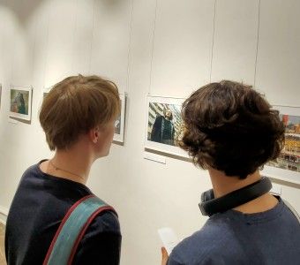 zdjęcie dwóch osób w galerii patrzą na fotografie na ścianach